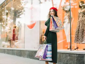 smiling-woman-with-colorful-packets-case