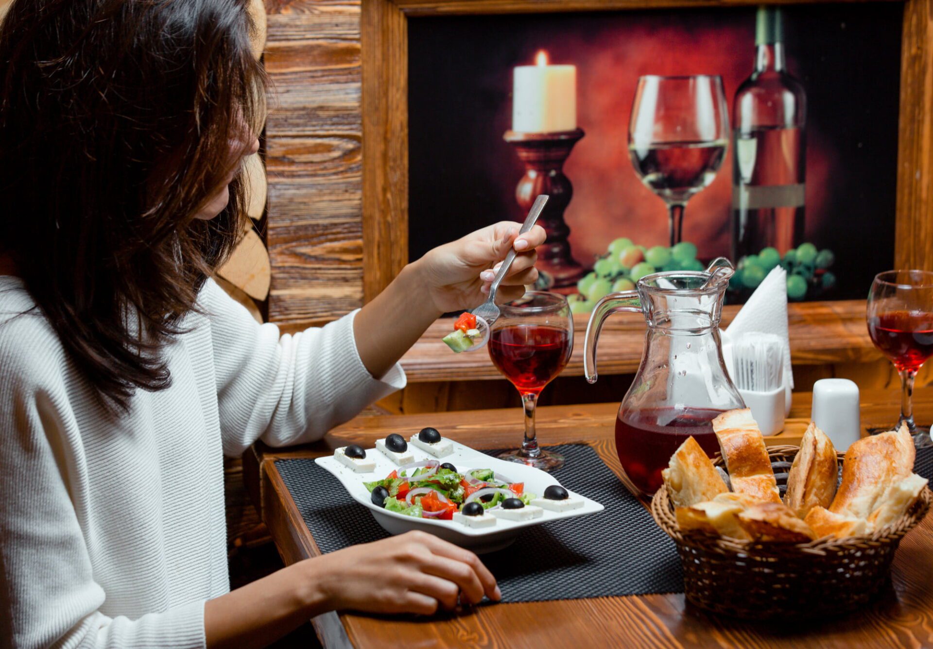 woman-eating-greek-salad-with-fruit-juice-bread