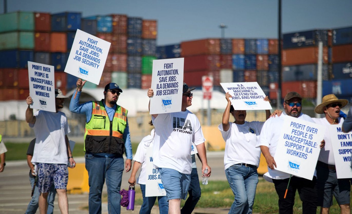 Close-up of a protest sign demanding fair wages for dock workers