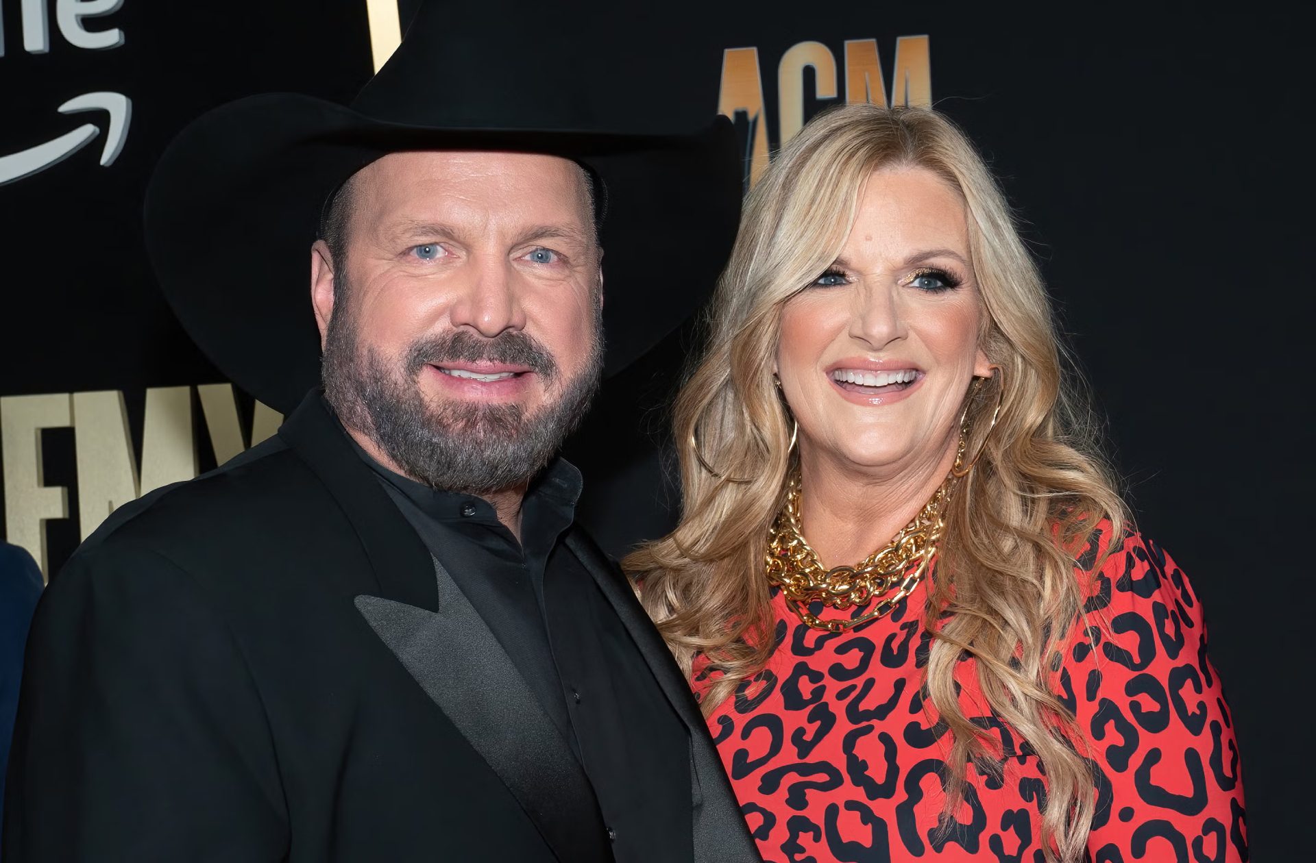 Garth Brooks and his wife, Trisha Yearwood, smiling together at a public event